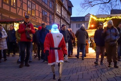 Humanoider Roboter läuft über einen Weihnachtsmarkt. 