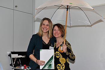 Zwei Personen stehen unter einem Regenschirm